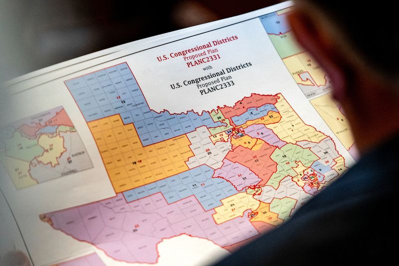 State Representative Matt Morgan (R-TX) holds a map of the new proposed congressional districts in Texas, during a legislative session as Democratic lawmakers, who left the state to deny Republicans the opportunity to redraw the state's 38 congressional districts, begin returning to the Texas State Capitol in Austin, Texas, U.S. August 20, 2025. REUTERS/Sergio Flores/File Photo