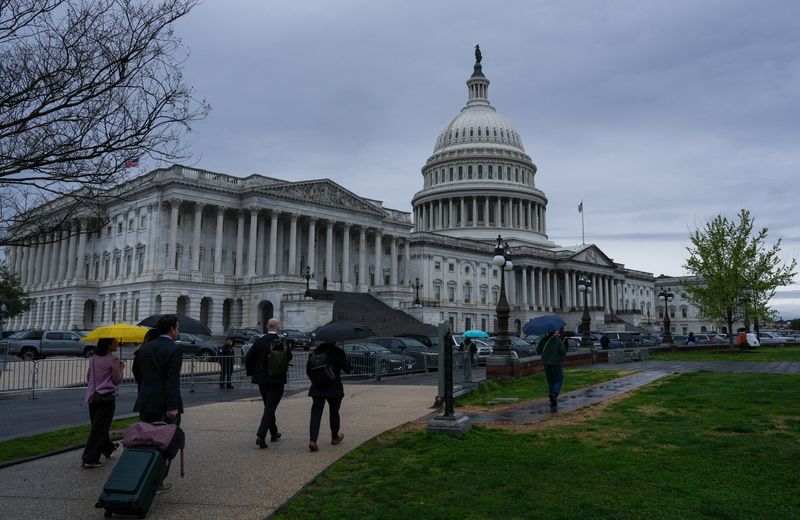 People walk near the U.S. Capitol building on Capitol Hill in Washington, D.C., U.S., March 27, 2026. REUTERS/Leah Millis