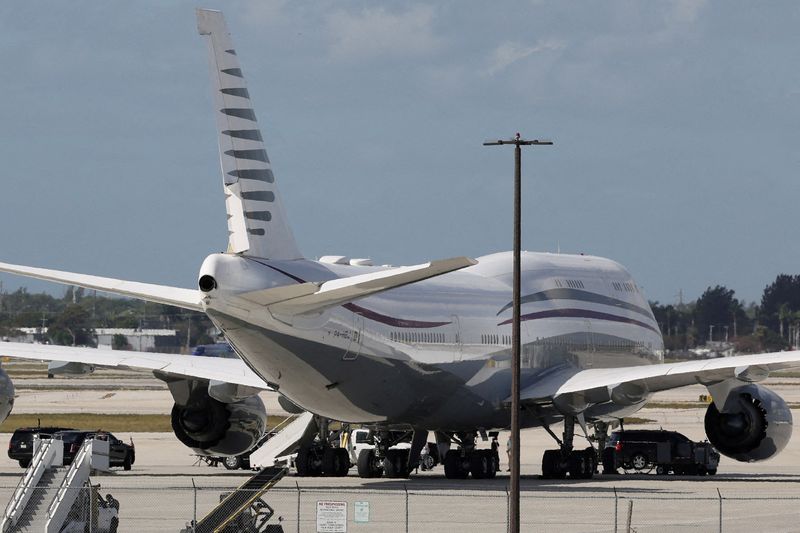 FILE PHOTO: The motorcade of U.S. President Donald Trump is parked next to a 12-year-old Qatari-owned Boeing 747-8 that Trump was touring in West Palm Beach, Florida, U.S., February 15, 2025. REUTERS/Kevin Lamarque/File Photo