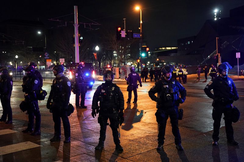Police officers stand guard after declaring unlawful assembly, as demonstrators gathered outside a hotel they believe is being used by federal agents, amid increased immigration enforcement in Minneapolis, Minnesota, U.S., February 5, 2026. REUTERS/Seth Herald