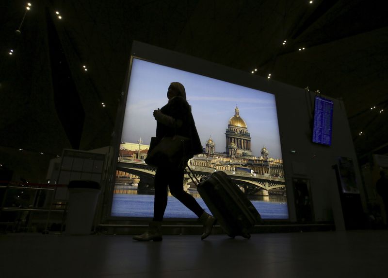 FILE PHOTO: A passenger with luggage walks at Pulkovo airport outside St. Petersburg, Russia, November 7, 2015. REUTERS/Peter Kovalev/File Photo