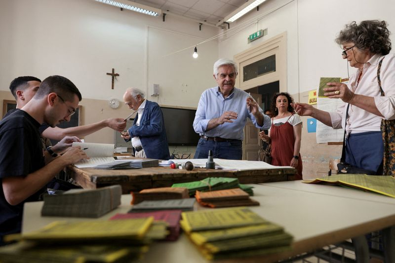 FILE PHOTO: People prepare to vote during a referendum on employment and Italian citizenship at a polling station in Rome, Italy, June 8, 2025. REUTERS/Matteo Minnella/File Photo