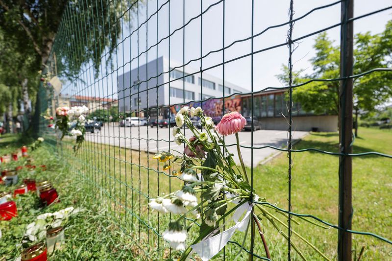 Flowers are seen on the fences of the school, following a deadly shooting at a secondary school, in Graz, Austria, June 12, 2025. REUTERS/Leonhard Foeger