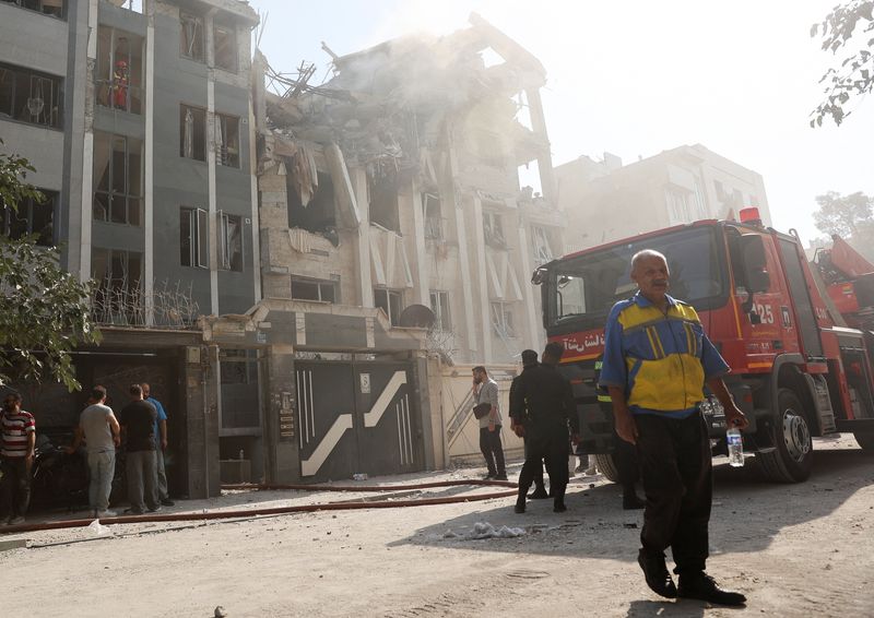 Rescuers work at the scene of a damaged building in the aftermath of Israeli strikes, in Tehran, Iran, June 13, 2025. Majid Asgaripour/WANA (West Asia News Agency) via REUTERS