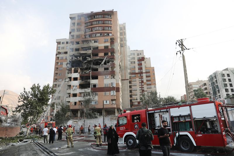 Firefighters work at the scene of a damaged building in the aftermath of Israeli strikes, in Tehran, Iran, June 13, 2025. Majid Asgaripour/WANA (West Asia News Agency) via REUTERS