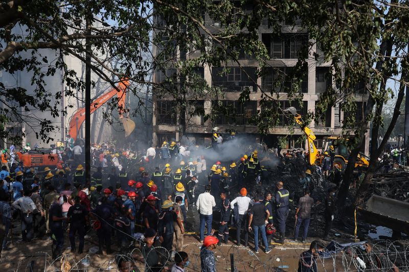 Rescue team members work at the site where an Air India Boeing 787 Dreamliner plane crashed in Ahmedabad, India, June 12, 2025. REUTERS/Amit Dave