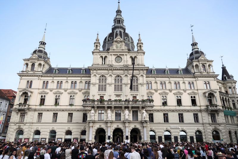 FILE PHOTO: People attend a memorial service at a main square in Graz, following a deadly shooting at a secondary school, Austria, June 11, 2025.  REUTERS/Leonhard Foeger/File Photo