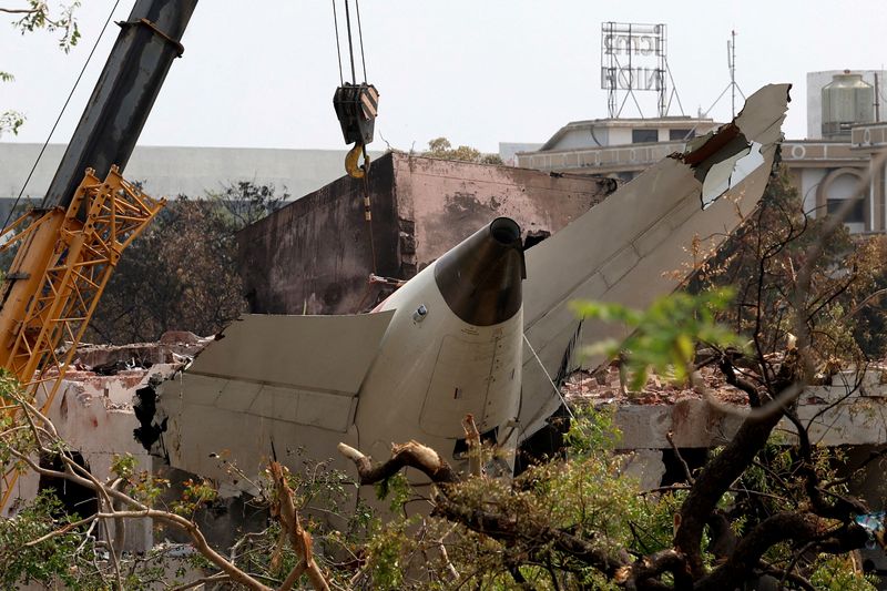 FILE PHOTO: A crane removes the wreckage of the Air India Boeing 787-8 Dreamliner aircraft, which crashed during take-off from an airport, in Ahmedabad, India June 14, 2025. REUTERS/Amit Dave/File Photo