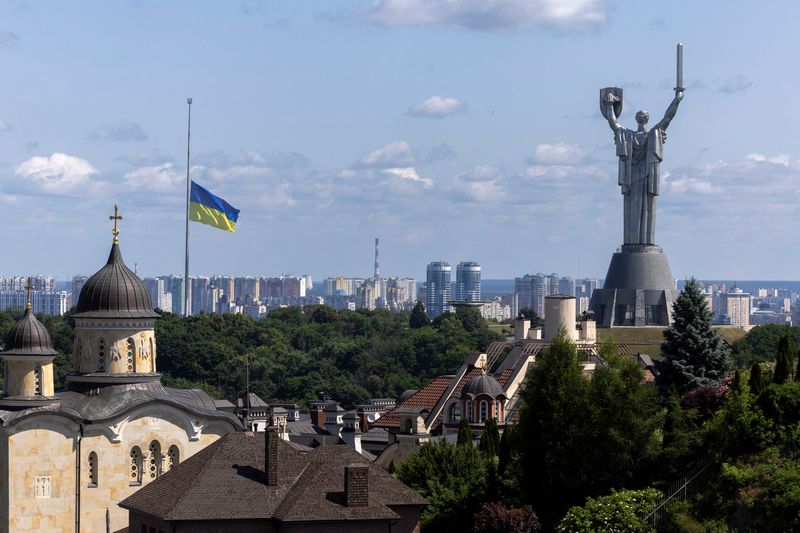 Ukrainian national flag flies at half-mast near the Ukrainian Motherland Monument after Tuesday's deadly Russian missile strike, amid Russia's attack on Ukraine, in Kyiv, Ukraine June 18, 2025. REUTERS/Thomas Peter