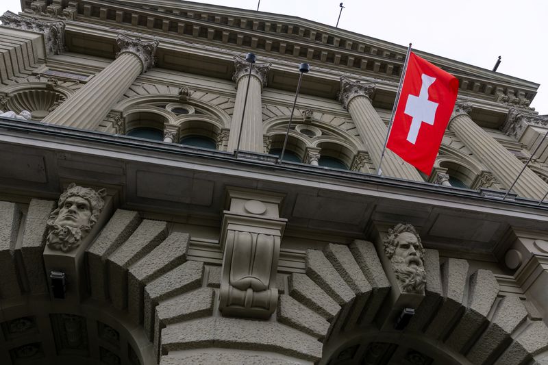 FILE PHOTO: A Swiss flag hangs at the Swiss Parliament building (Bundeshaus) in Bern, Switzerland, March 12, 2025. REUTERS/Denis Balibouse/File photo