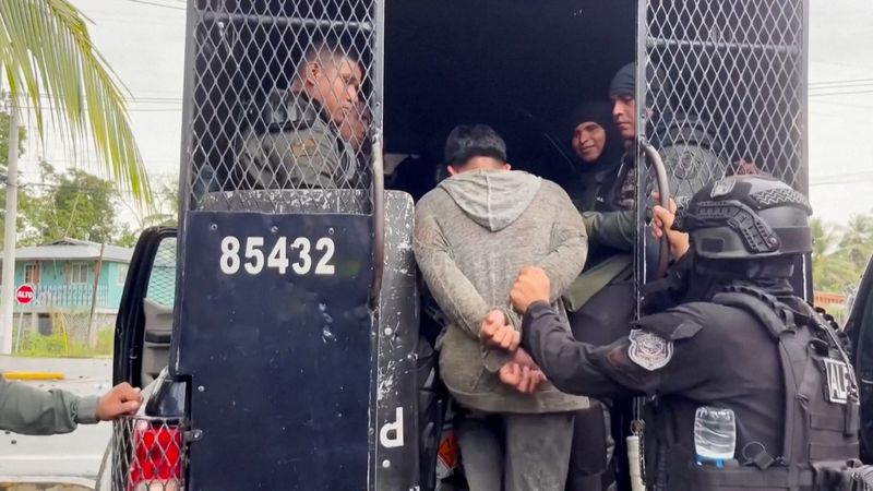 A detained demonstrator is loaded into a police vehicle during an operation by the police to clear roadblocks set up by protesters as part of a widespread strike by workers of the Chiquita banana company, which had ceased operations in the area, and are part of broader protests against social security reforms, in Bocas del Toro, Panama, June 14, 2025, in this still image taken from video.  Reuters TV/via REUTERS
