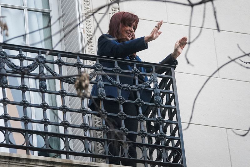 FILE PHOTO: Former Argentinian President Cristina Fernandez de Kirchner gestures from the balcony of her home after Argentina's Supreme Court upheld her guilty verdict for defrauding the state, in Buenos Aires, Argentina, June 13, 2025. REUTERS/Mariana Nedelcu/File Photo