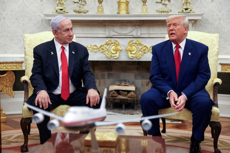 FILE PHOTO: FILE PHOTO: U.S. President Donald Trump talks to Israeli Prime Minister Benjamin Netanyahu during a meeting where Trump announced nuclear talks with Iran, Washington, U.S., April 7, 2025. REUTERS/Kevin Mohatt/File Photo/File Photo