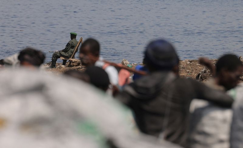 FILE PHOTO: An M23 rebel sits at the quay in front of the Kituku market in Goma, which is controlled by M23 rebels, in North Kivu province of the Democratic Republic of Congo March 21, 2025. REUTERS/Zohra Bensemra/File photo