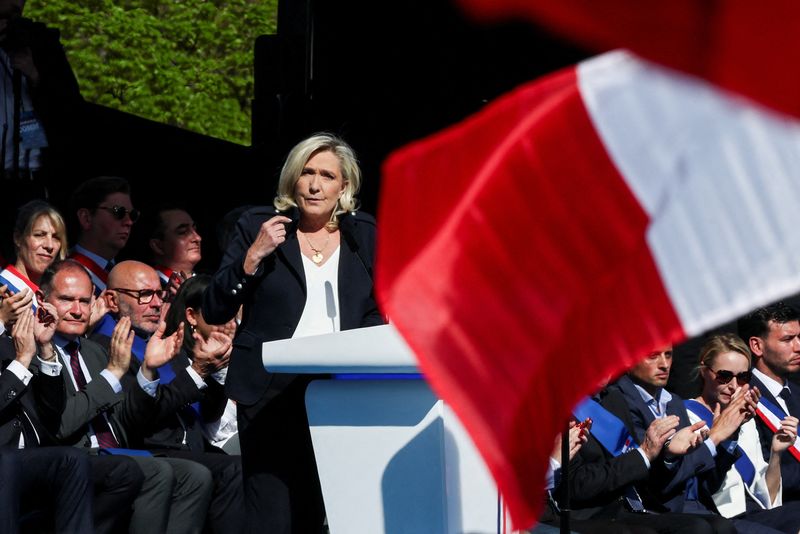 FILE PHOTO: French far-right leader Marine Le Pen speaks at a rally in support of her, after calls for a peaceful mobilisation following Marine Le Pen's conviction for embezzlement of EU funds, resulting in her being barred from running for office for five years, in Paris, France, April 6, 2025. REUTERS/Gonzalo Fuentes/File Photo