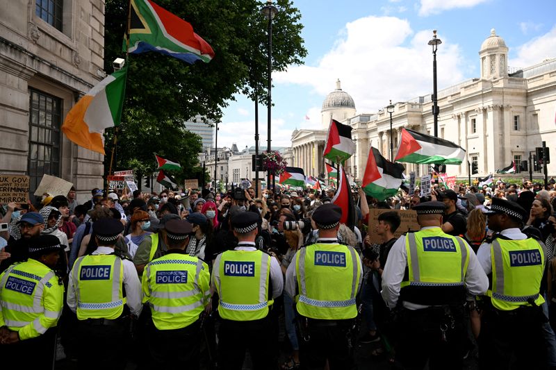 FILE PHOTO: Police officers block a street as pro-Palestinian demonstrators gather in protest against Britain's Home Secretary Yvette Cooper's plans to proscribe the "Palestine Action" group in the coming weeks, in London, Britain, June 23, 2025. REUTERS/Jaimi Joy/File Photo
