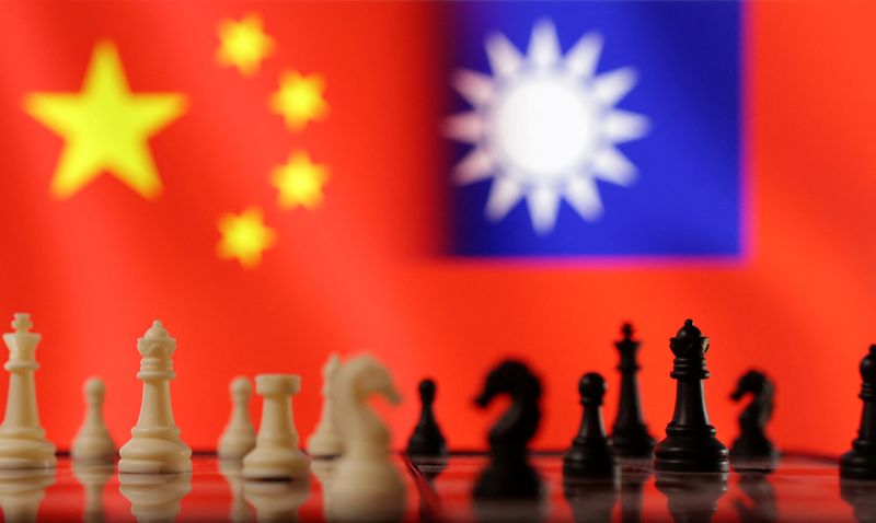 FILE PHOTO: Chess pieces are seen in front of displayed Chinese and Taiwanese flags in this illustration taken, April 11, 2023. REUTERS/Dado Ruvic/Illustration/File Photo
