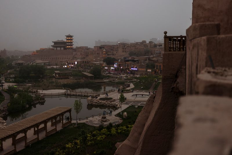 FILE PHOTO: A Chinese pagoda overlooks the old city in Kashgar, Xinjiang Uyghur Autonomous Region, China, May 4, 2021. Picture taken May 4, 2021. REUTERS/Thomas Peter/File photo