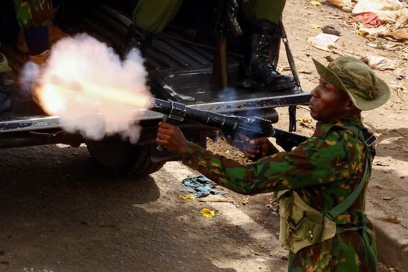 A riot police officer fires tear gas during clashes with demonstrators at the "Saba Saba People's March" anti-government protest in Nairobi, Kenya July 7, 2025. REUTERS/Thomas Mukoya