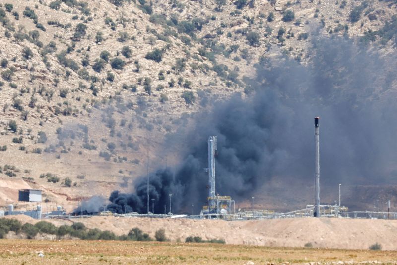 FILE PHOTO: Smoke rises after a drone attack targeted oil facilities in the Zakho area of Iraq's Kurdistan region, Iraq July 16, 2025. REUTERS/Khalid Al-Mousily/File Photo
