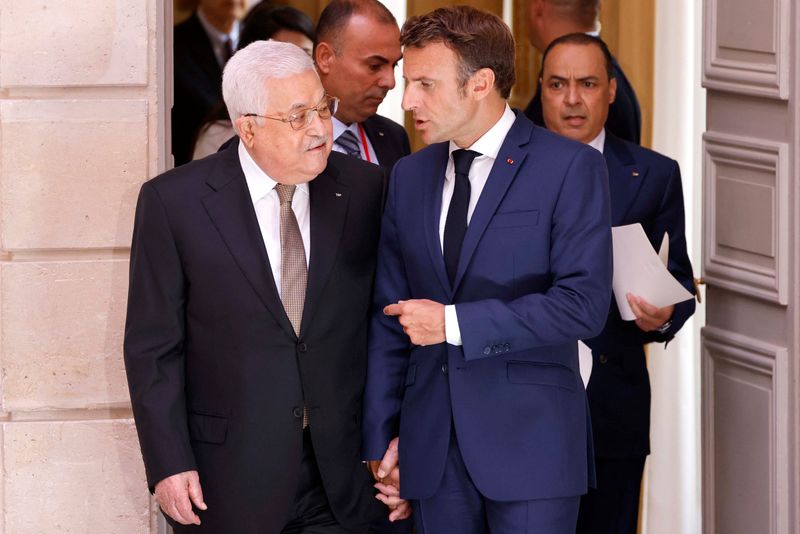French President Emmanuel Macron speaks with Palestinian President Mahmoud Abbas as they walk to a meeting at the Elysee Presidential Palace in Paris, France July 20, 2022. Ludovic Marin/Pool via REUTERS/File Photo