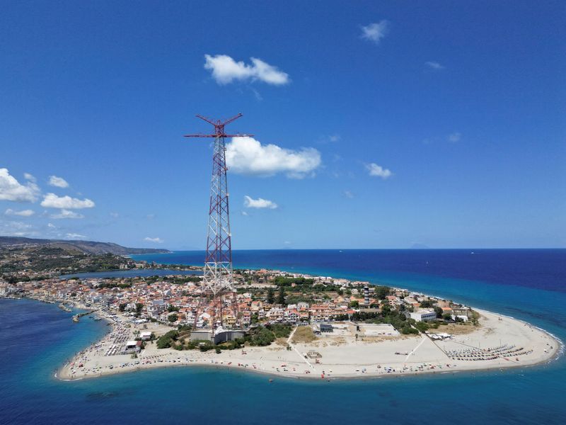 A drone view shows the Sicilian coast visible across the Strait of Messina, part of the planned site for construction of a suspension bridge connecting Sicily to mainland Italy, with construction expected to be completed in 2032, in Messina, Italy, August 6, 2025. REUTERS/Yara Nardi