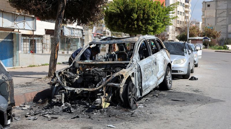 FILE PHOTO: A man inspects a damaged car in Latakia, after hundreds were reportedly killed in some of the deadliest violence in 13 years of civil war, pitting loyalists of deposed President Bashar al-Assad against the country's new Islamist rulers, Syria March 9, 2025. REUTERS/Haidar Mustafa/File photo