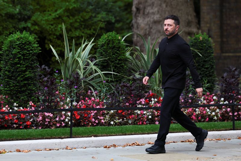 FILE PHOTO: Ukrainian President Volodymyr Zelenskiy walks to meet British Prime Minister Keir Starmer at Downing Street, in London, Britain, August 14, 2025. REUTERS/Isabel Infantes/File Photo