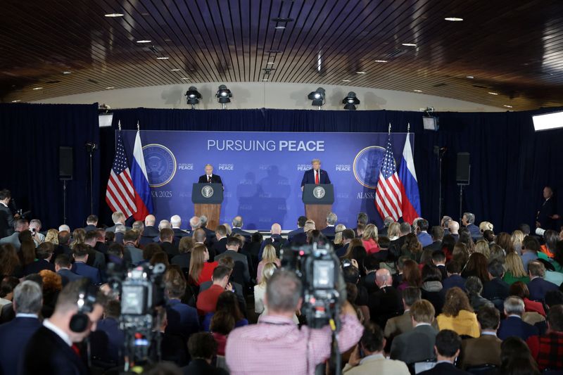 U.S. President Donald Trump and  Russian President Vladimir Putin hold a press conference following their meeting to negotiate an end to the war in Ukraine, at Joint Base Elmendorf-Richardson in Anchorage, Alaska, U.S., August 15, 2025. REUTERS/Jeenah Moon