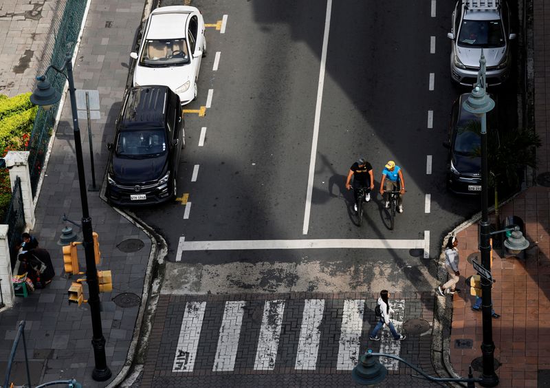 People walk through a street of downtown Guayaquil, in Guayaquil, Ecuador April 10, 2025. REUTERS/Daniel Becerril/File Photo