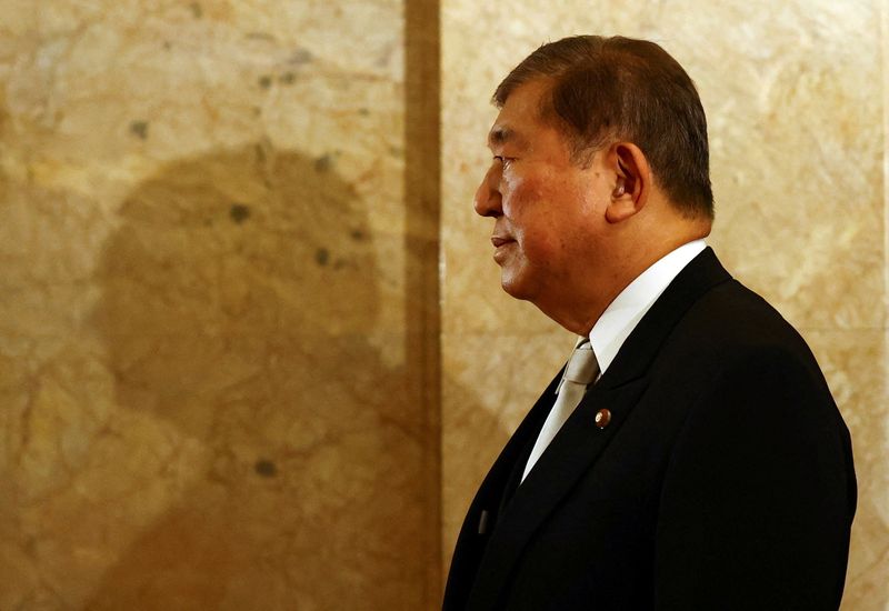 FILE PHOTO: Japan's Prime Minister Shigeru Ishiba, wearing a formal attire, walks toward the upper house hall to attend an opening ceremony of the parliamentary session in Tokyo, Japan August 1, 2025.  REUTERS/Issei Kato/File photo
