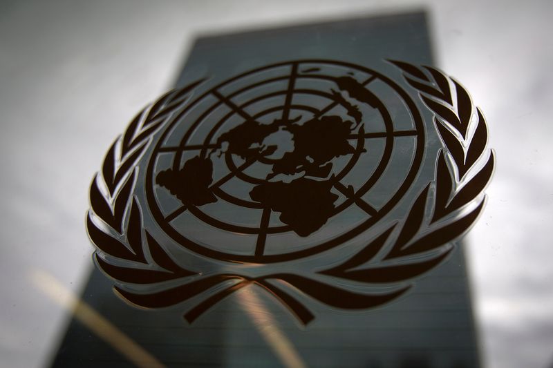 FILE PHOTO: The United Nations headquarters building is pictured through a window with the UN logo in the foreground in the Manhattan borough of New York August 15, 2014/File Photo