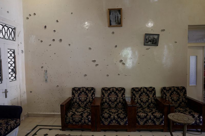 FILE PHOTO: A wall is pockmarked by bullet holes inside the Saraya family house, following sectarian violence in Syria's Sweida province, where government forces were sent to quell local clashes between Druze armed factions and Bedouin tribal fighters, in the predominantly Druze city of Sweida, Syria, July 25, 2025. REUTERS/Khalil Ashawi/File Photo