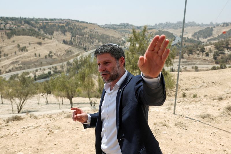 FILE PHOTO: Israeli Finance Minister Bezalel Smotrich gestures, on the day of a press conference regarding settlements expansion for the long-frozen E1 settlement, that would split East Jerusalem from the occupied West Bank, near the Israeli settlement of Maale Adumim in the Israeli-occupied West Bank, August 14, 2025. REUTERS/Ronen Zvulun/File Photo