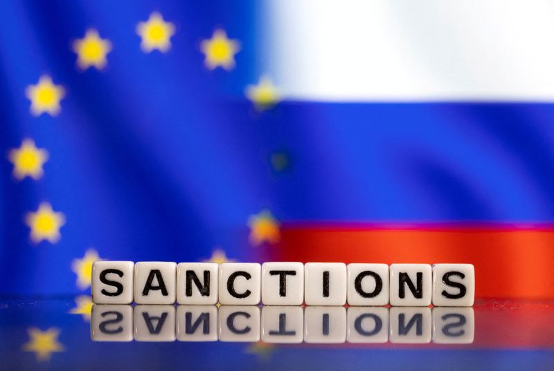 Plastic letters arranged to read "Sanctions" are placed in front of EU and Russia's flag colors in this illustration taken February 25, 2022. REUTERS/Dado Ruvic/Illustration