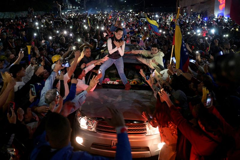 FILE PHOTO: Venezuelan opposition leader Maria Corina Machado greets supporters atop a vehicle during a campaign rally for the presidential election, in Merida state, Venezuela June 25, 2024. REUTERS/Gaby Oraa//File Photo