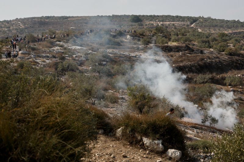 Smoke rises at the scene of a clash between Israeli soldiers and Palestinian protesters who went out to pray on their land, threatened by Israeli settlement expansion, in Beit Lid, near Tulkarm, in the Israeli-occupied West Bank, November 7, 2025. REUTERS/Raneen Sawafta