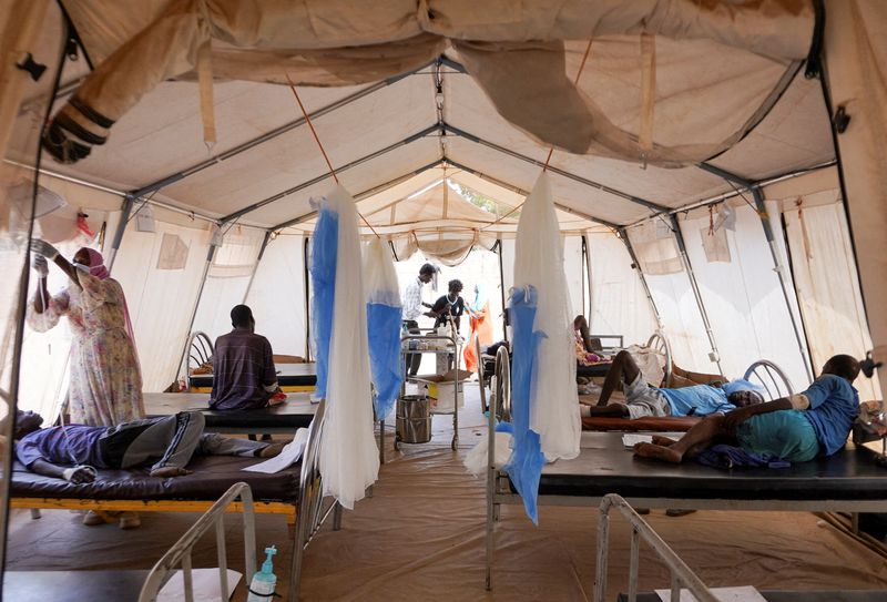 FILE PHOTO: Injured displaced Sudanese people who fled violence in al-Fashir receive treatment at a makeshift clinic run by Medecins Sans Frontieres (MSF), amid ongoing clashes between the paramilitary Rapid Support Forces (RSF) and the Sudanese army, in Tawila, North Darfur, Sudan November 3, 2025. REUTERS/Mohamed Jamal/File Photo
