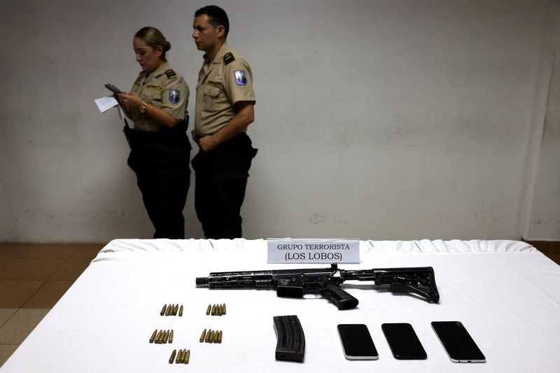 FILE PHOTO: A weapon is shown at a police station in the aftermath of a wave of violence that saw the storming of a TV station on-air and explosions around the nation, in Guayaquil, Ecuador, January 11, 2024. The sign reads 'Terrorist group Los Lobos'. REUTERS/Ivan Alvarado/File Photo