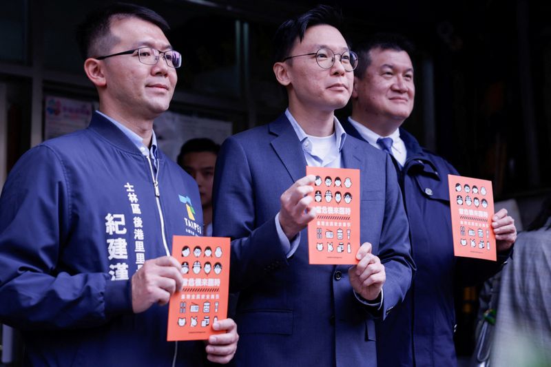 Deputy Secretary-General of Taiwan's National Security Council Lin Fei-fan holds a civil defence handbook in Taipei, Taiwan November 21, 2025. REUTERS/Ann Wang