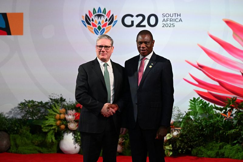 British Prime Minister Keir Starmer is greeted by Deputy President of South Africa Paul Mashatile as he arrives at the G20 Summit on November 22, 2025 in Johannesburg, South Africa. Leon Neal/Pool via REUTERS