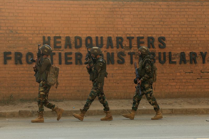 Army soldiers walk, after suicide bombers targeted the headquarters of a Pakistani paramilitary force in Peshawar, Pakistan November 24, 2025. REUTERS/Fayaz Aziz