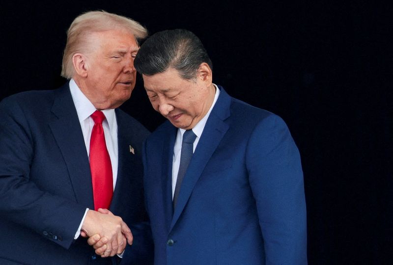 FILE PHOTO: U.S. President Donald Trump and Chinese President Xi Jinping talk as they leave after a bilateral meeting at Gimhae International Airport, on the sidelines of the Asia-Pacific Economic Cooperation (APEC) summit, in Busan, South Korea, October 30, 2025. REUTERS/Evelyn Hockstein/File Photo