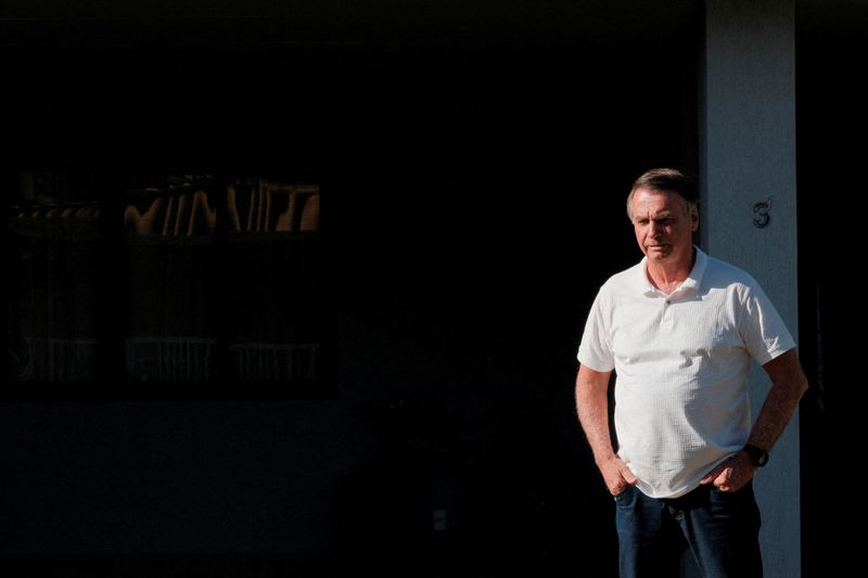 FILE PHOTO: Brazil’s former President Jair Bolsonaro looks on from his home as Sao Paulo’s Governor Tarcisio de Freitas (not pictured) leaves after a visit in Brasilia, Brazil September 29, 2025. REUTERS/Diego Herculano/File Photo