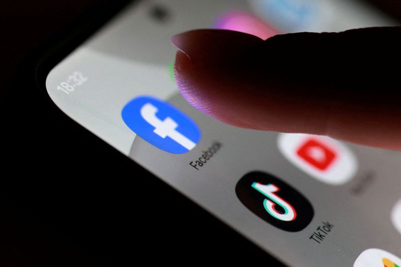 FILE PHOTO: The Facebook, TikTok and YouTube app icons are seen on a smartphone in this illustration taken October 27, 2025. REUTERS/Dado Ruvic/File Photo