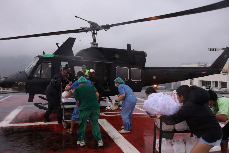 Medical crew carry a patient who is in critical condition, on a stretcher, as they transfer to a military helicopter from Hat Yai Hospital to Songklanagarind Hospital, amid heavy flooding in Hat Yai district, which was affected by heavy rainfall impacting several provinces in southern Thailand and killing several people, in Songkhla province, Thailand, November 26, 2025. Royal Thai Army/Handout via REUTERS