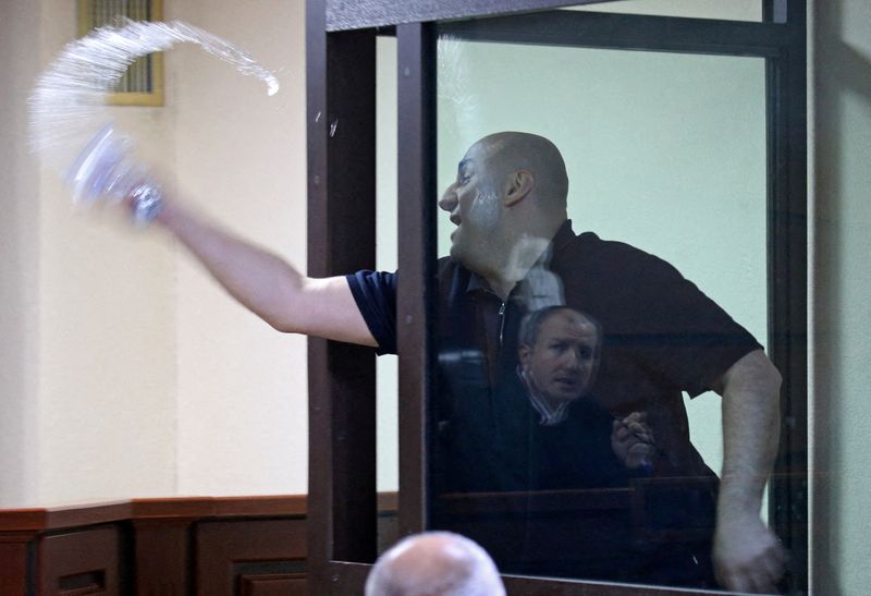 FILE PHOTO: Nika Melia, one of the leaders of the Coalition for Change opposition group, charged with failing to appear before the Georgian parliament's temporary investigative commission, splashes water towards a judge during a court hearing in Tbilisi, Georgia May 30, 2025. REUTERS/Irakli Gedenidze/Pool/File Photo