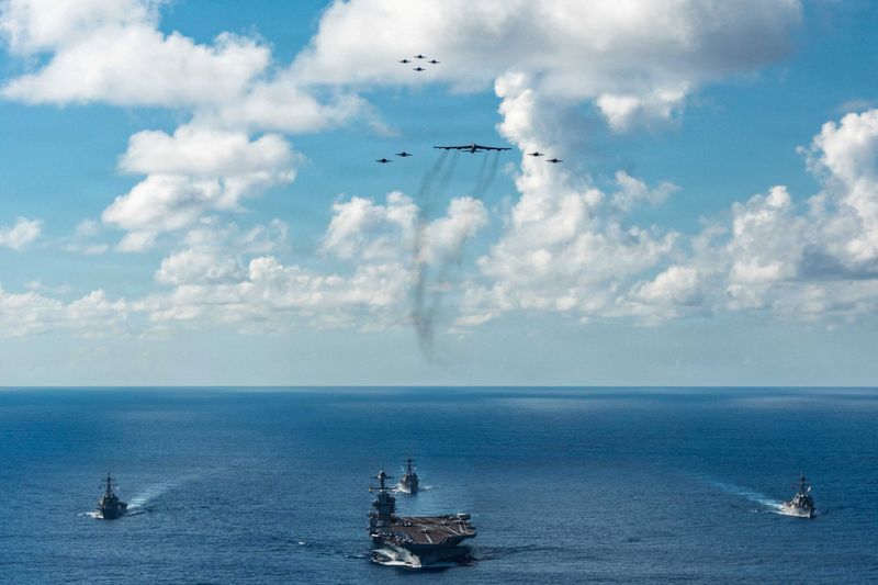 FILE PHOTO: The U.S. Navy’s Gerald R. Ford Carrier Strike Group, including the flagship USS Gerald R. Ford, USS Winston S. Churchill, USS Mahan and USS Bainbridge, sail towards the Caribbean Sea under F/A-18E/F Super Hornets and a U.S. Air Force B-52 Stratofortress, in the Atlantic Ocean November 13, 2025.  U.S. Navy/Petty Officer 3rd Class Gladjimi Balisage/Handout via REUTERS. THIS IMAGE HAS BEEN SUPPLIED BY A THIRD PARTY/File Photo