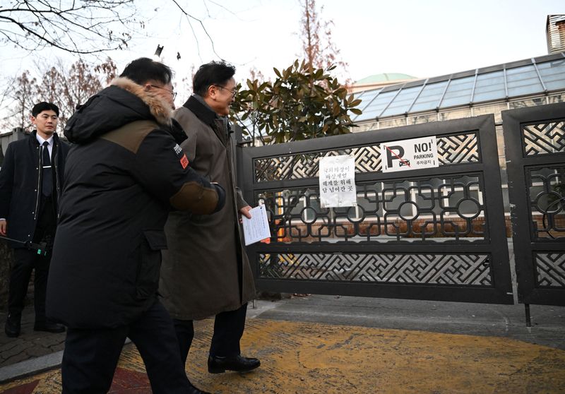 National Assembly Speaker Woo Won-shik guides visitors as he walks along the wall he jumped over a year ago, during a dark tour on martial law sites to mark the first anniversary of the declaration of martial law by ousted president Yoon Suk Yeol, at the National Assembly in Seoul, South Korea, December 3, 2025. Jung Yeon-Je/Pool via REUTERS