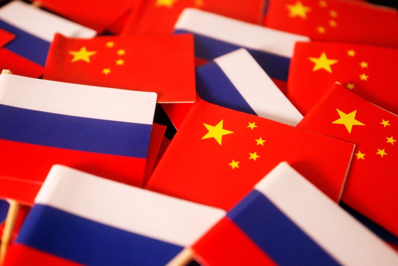 Flags of China and Russia are displayed in this illustration picture taken March 24, 2022. REUTERS/Florence Lo/Illustration